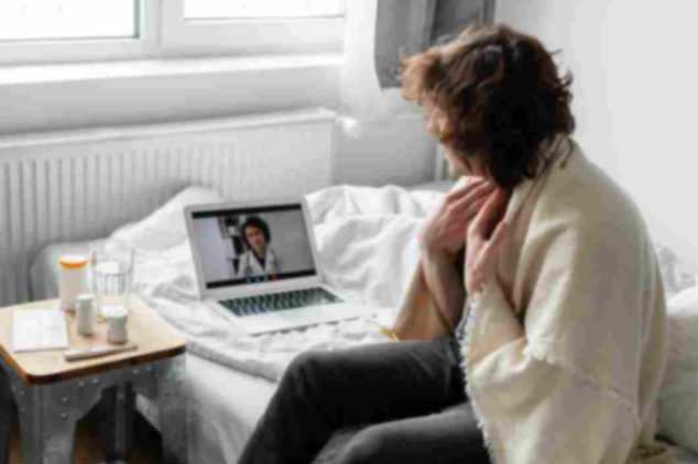 Man at home using medication management online during a secure video appointment with a provider