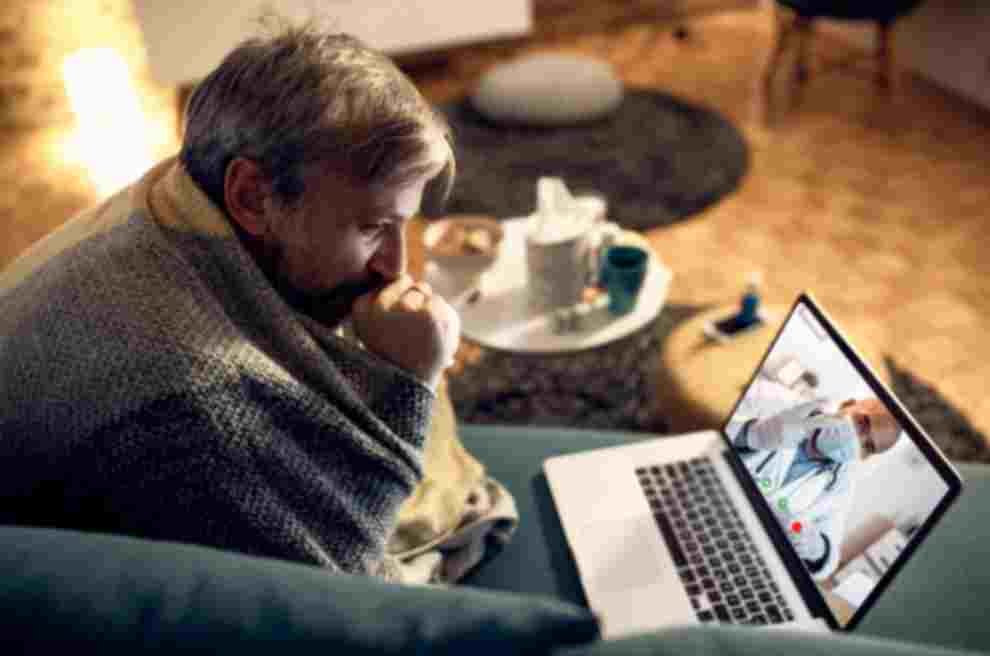 Man at home during evening telepsychiatry services video call for psychiatric medication management