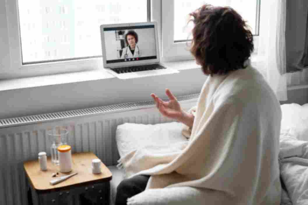 Young adult completing online mental health evaluation with provider during private video appointment