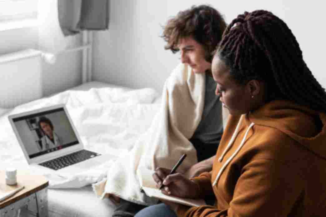 Patient taking notes during online counseling Harford County telepsychiatry services visit